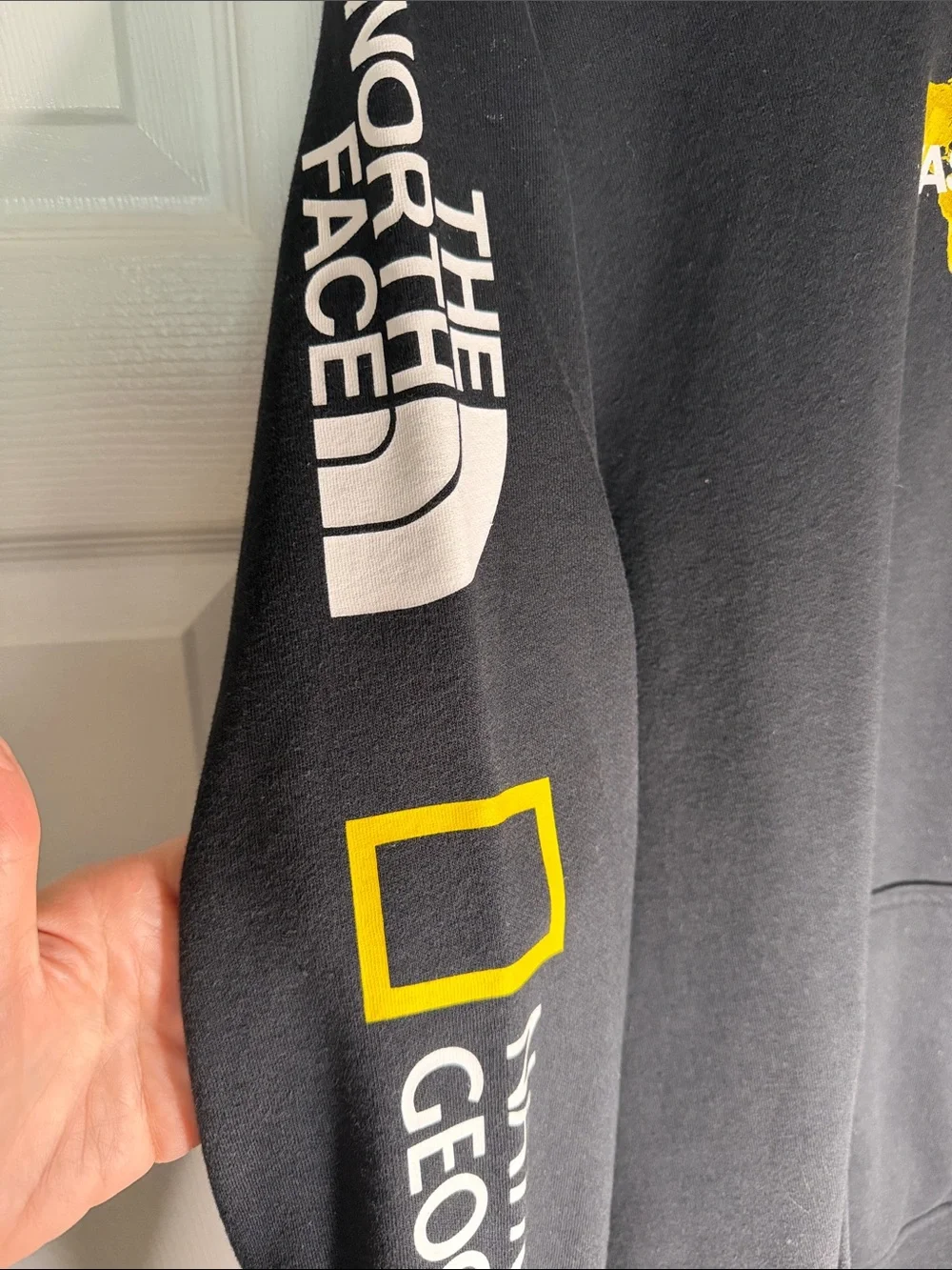 The North Face Black Hoodie with Yellow Map Accent